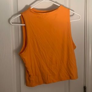 orange sleeveless shirt